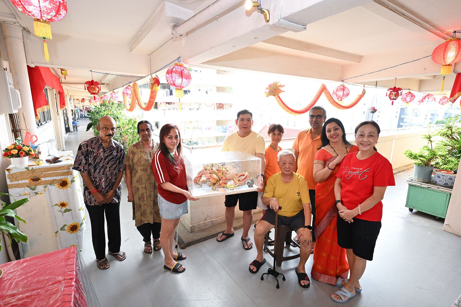 (From left) The long-time neighbours with their Chinese New Year decorations. Mr G. Manoharan, 69; Madam M. Letchini, 68; Madam Toh Siew Mue, 57; Mr Tan Chwee Beng, 61; Madam Tok Le Hiong, 61; Mr Ng Teck Min, 86; Mr Jujeet Singh, 68; Mrs Shobha Singh, 50; and Madam Tan Lee Hua, 65. ST PHOTO: LIM YAOHUI