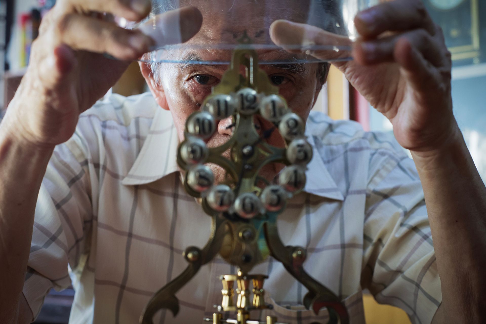 Mr Mun taking a closer look at his Gustav Becker 400-day skeleton clock. Like most 400-day clocks that have been properly serviced and adjusted, they do not require frequent attention, except to adjust the time once a while.