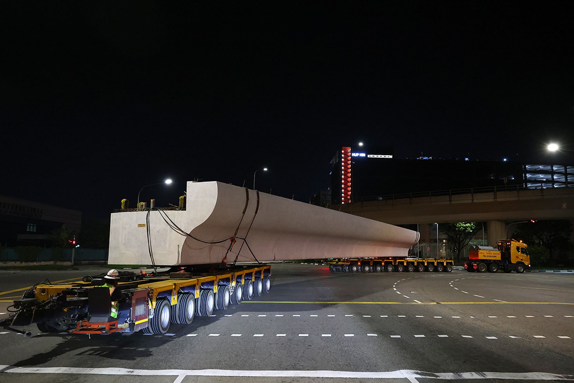 The beam being transported from the precast yard to the construction site on March 22.