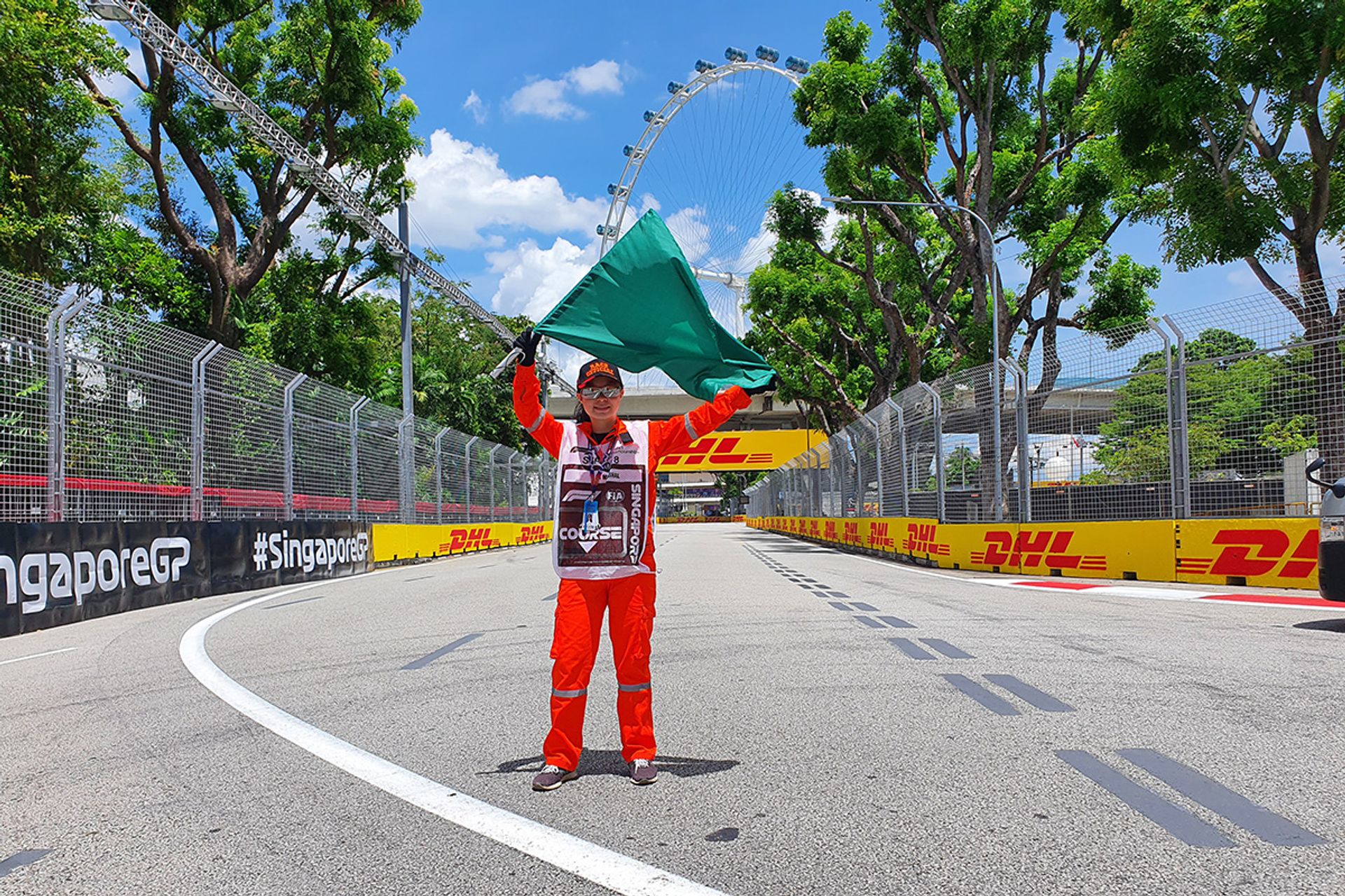 Ms Vanessa Kang working as a volunteer flag marshal in 2022 at Turn 19. PHOTO: COURTESY OF VANESSA KANG