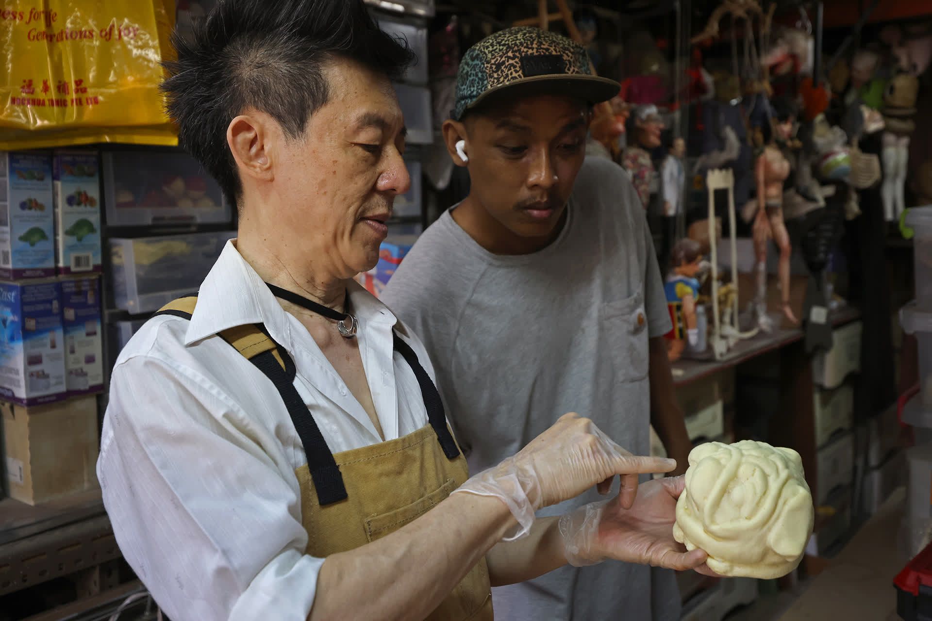 Mr Yeo inspecting a moulded dog puppet head with Mr Syaiful, his production assistant of four years. Mr Syaiful said: “Frankie is very generous with his knowledge.”