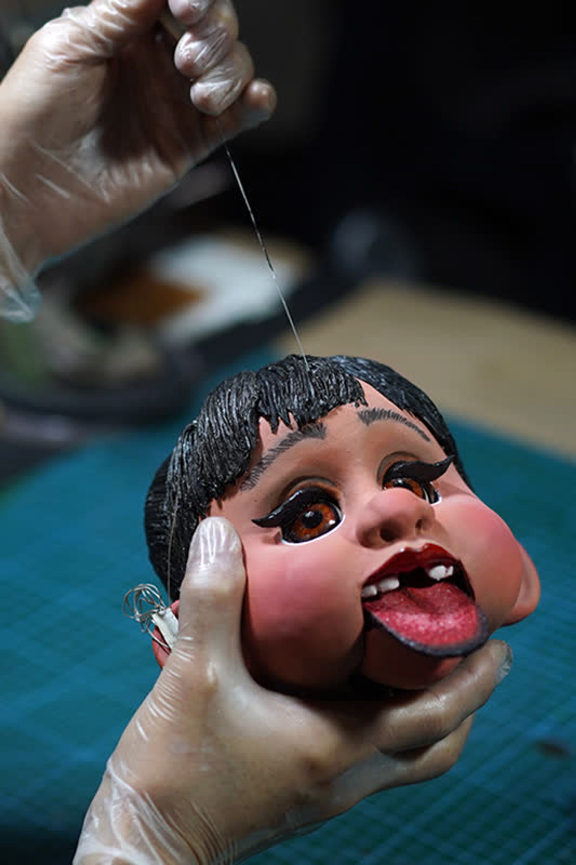 Mr Yeo testing how well a puppet can stick out its tongue.