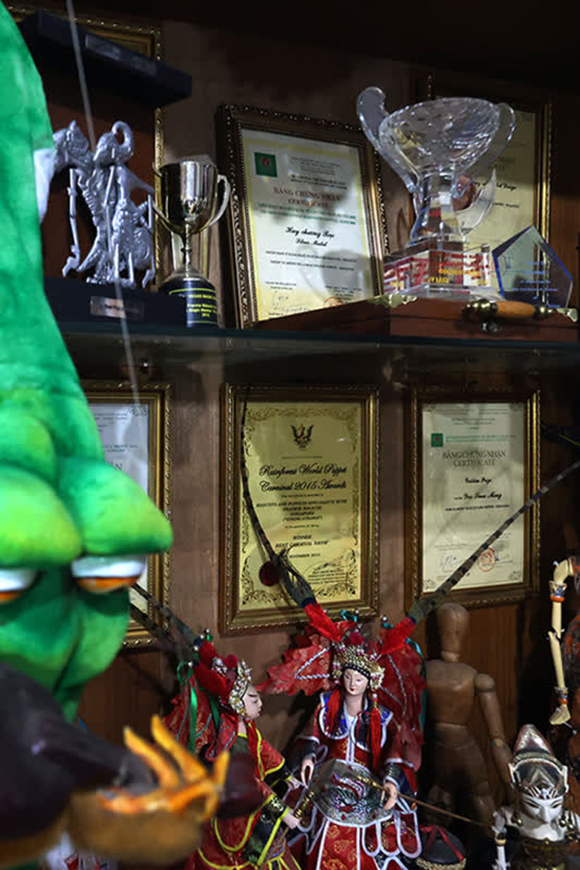 Mr Yeo’s framed puppet competition awards.