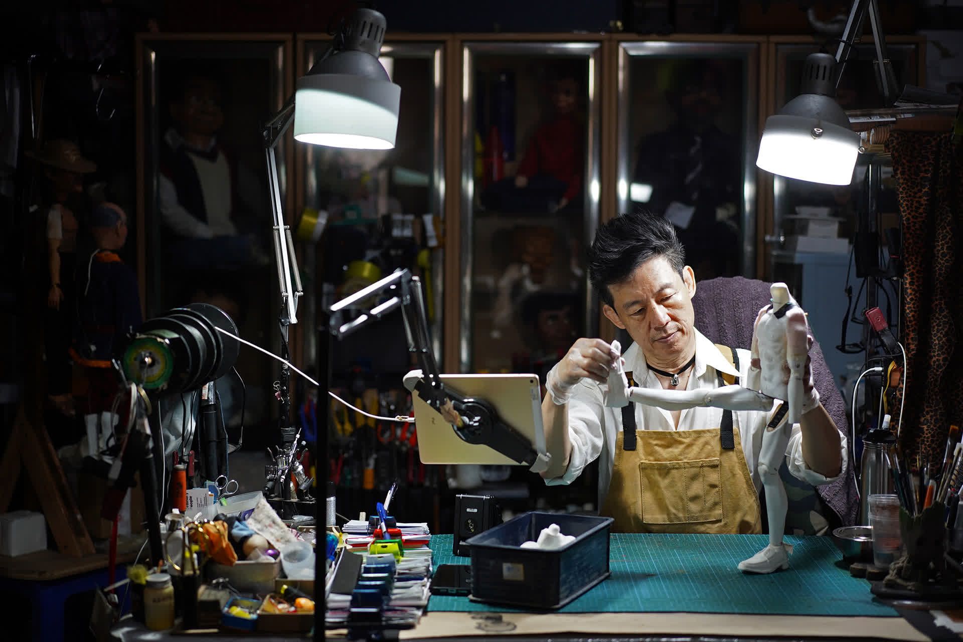 Mr Yeo checking the mobility of a puppet in his studio.